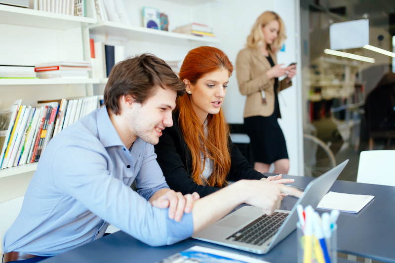 Business Coworkers Consulting by a Computer