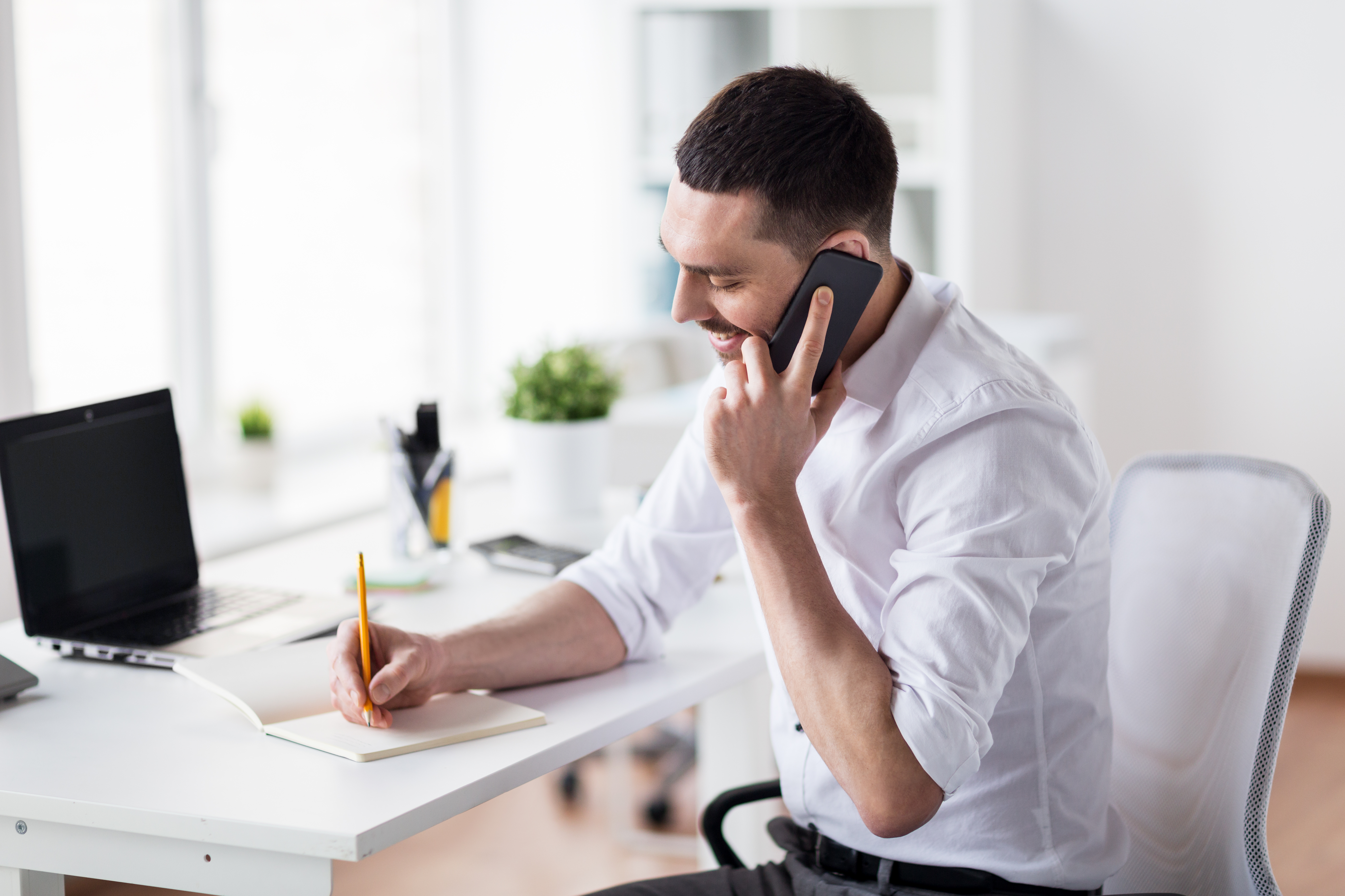 Businessman Calling On Smartphone At Office