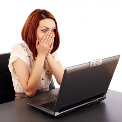 Shocked woman looking at computer screen