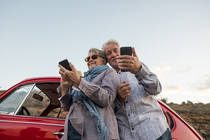 Elderly Couple On Mobile Devices