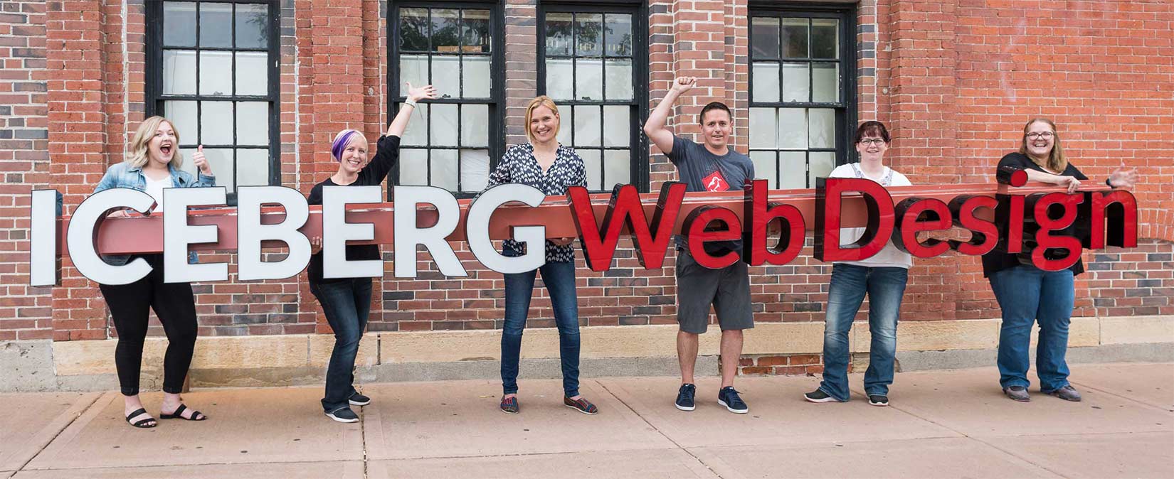 Iceberg Web Design Staff With Building Sign