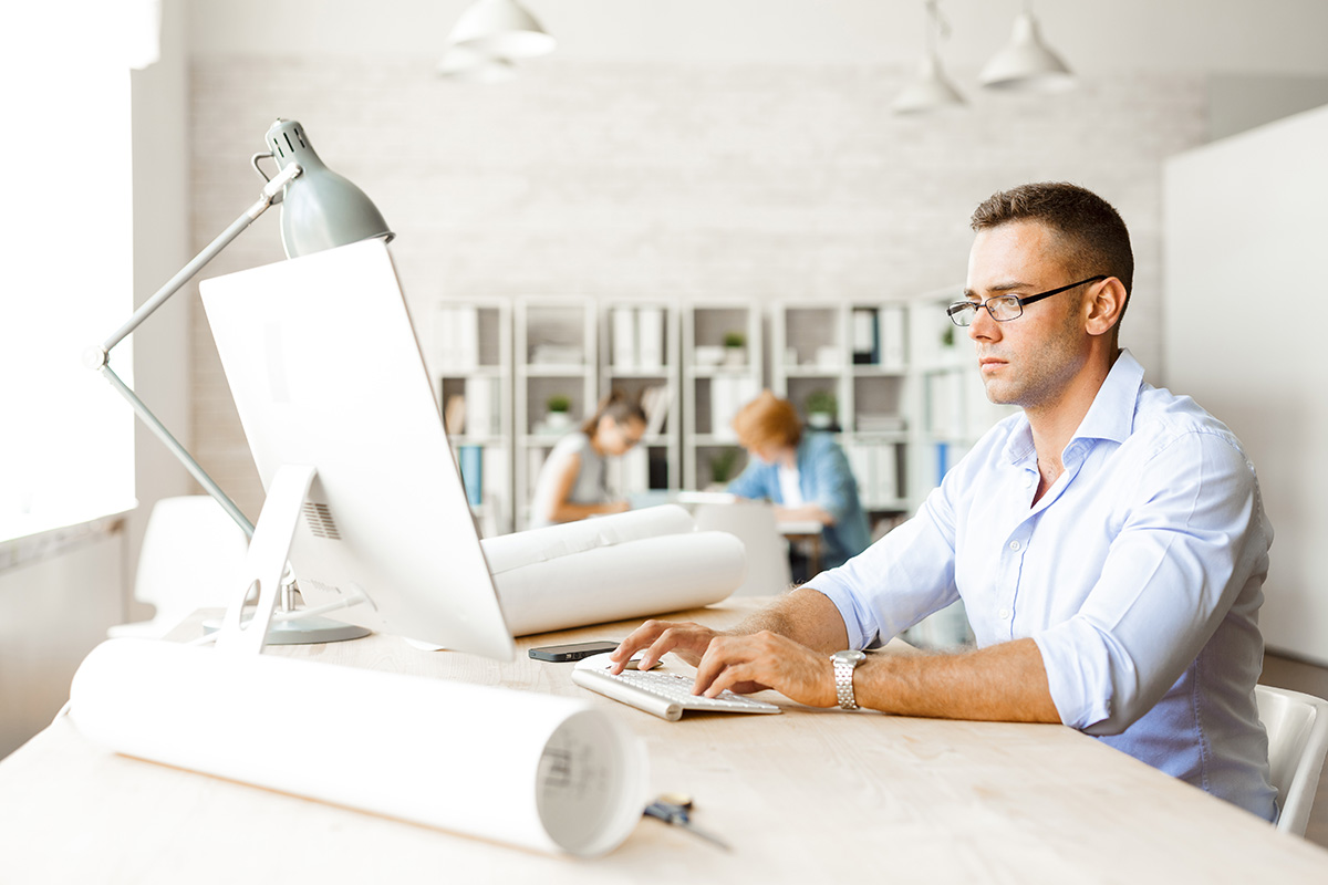 Man Browsing Internet On Mac Computer