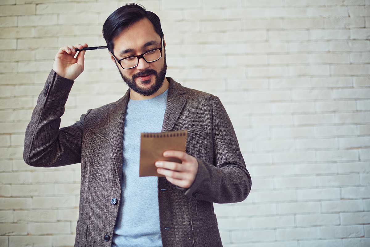 Man Looking at his Notebook